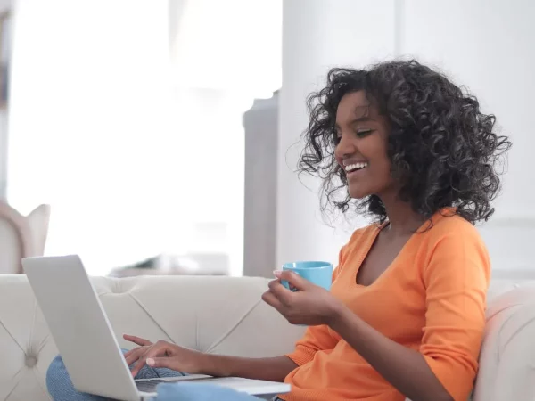 /app/uploads/2025/06/cheerful-woman-with-cup-of-coffee-surfing-laptop-3960563-e1621333991755.webp